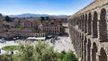 Iconic Roman aqueduct of Segovia with historical buildings in the background