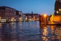 Iconic scene along the Venetian Canals of gondoliers in late afternoon sun.