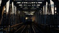 The iconic silhouette of a train crossing a towering iron bridge Royalty Free Stock Photo