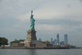 Iconic Statue of Liberty standing proudly in front of tall skyscrapers