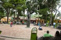 Iconic statue of Simon Bolivar in Plaza Bolivar in El Hatillo and people, children,women and men spending time playing and resting Royalty Free Stock Photo