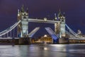 The iconic Tower Bridge in London at night, beautifully illuminated and with raised bascules Royalty Free Stock Photo