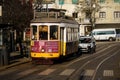 Iconic Tram 28 Riding Through the Historic Streets of Lisbon, Portugal on a Sunny Day Royalty Free Stock Photo