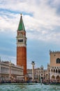 Iconic view of St Mark's campanile and columns by waterfront of piazzetta on St Mark square, Grand Canal, Venice, Italy Royalty Free Stock Photo