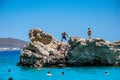 Iconic view of a young child, playing on kaladi beach in Kythira island, Ionian sea, Greece, Europe