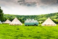 An iconic VW Camper or Kombi at a glamping site in the English countryside
