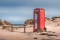 The iconic and weathered red telephone box on Shell Bay beach, Studland, near Sandbanks, Dorset, UK Royalty Free Stock Photo