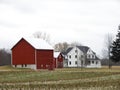 Iconic white farmhouse with red barns in NYS FingerLakes countryside Royalty Free Stock Photo