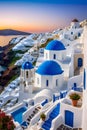 The iconic whitewashed buildings of Santorini, sunset, sea, mountain, cliff, romantic ambience, travel destination Royalty Free Stock Photo