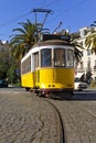 Iconic 100 year old Lisbon yellow tram in Campo das Cebolas Royalty Free Stock Photo