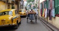 The iconic yellow ambassador taxi Kolkata and a hand pulled rickshaw