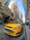 An iconic yellow cab in downtown Manhattan