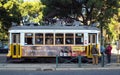 Iconic yellow tram car, No 28, at the Estrela stop, Lisbon, Portugal Royalty Free Stock Photo