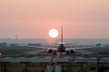 Iconical image of Airplane landing at an airport at sunset Royalty Free Stock Photo