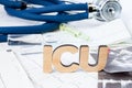 ICU Abbreviation or acronym of intensive care unit in hospital or clinic, special medical unit. Word ICU is on ECG stripes in fore