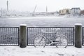 Icy bicycle next to river