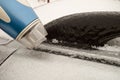 Icy car body and a door that cannot be opened after freezing rain. Warming up using hairdryer. Royalty Free Stock Photo