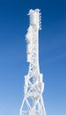 Icy cellular base station antenna covered with snow. Cell site tower on moutain hill Royalty Free Stock Photo