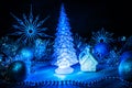 Icy Christmas tree glowing with blue light on a blue background Royalty Free Stock Photo