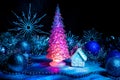 Icy Christmas tree glowing with red light on a blue background Royalty Free Stock Photo