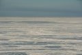 The icy desert that the winter-frozen Gulf of Finland has become, under the sky in a cloudy haze in direct sunlight. Royalty Free Stock Photo
