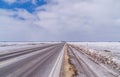 Icy Highway with cloudy skies. Royalty Free Stock Photo