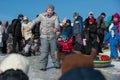 On the icy hill a crowd of children. Sliding down they slide. Smiling, having fun. Sunlight