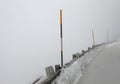 Icy mountain road with poor visibility due to thick fog Royalty Free Stock Photo