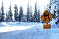 Icy patches road warning sign in deep snow irony ironic Royalty Free Stock Photo