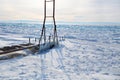 Icy pier, a device for launching a boat into the lake. Frozen Lake Baikal, hummocks Royalty Free Stock Photo