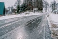 Icy road on the edge of a snow-covered village at the edge of the forest Royalty Free Stock Photo