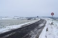 icy road into snowy village Welling in the valley