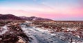 Icy slippery Arctic road through the tundra. Northern winter road. Magenta polar sunset