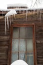 Icy, small icicles hang on the edge of the roof, winter or spring. Royalty Free Stock Photo