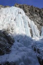 Icy streams of water frozen on the rocks against the blue sky Royalty Free Stock Photo