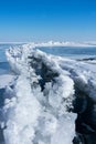 A dangerous crack in the ice of a frozen bay in winter. Open cracked ice on the lake. Royalty Free Stock Photo