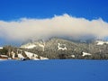 Icy winter atmosphere and low clouds on a snowy peak Stockberg 1781 m in the Alpstein mountain range and in the Obertoggenburg