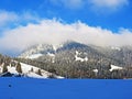 Icy winter atmosphere and low clouds on a snowy peak Stockberg 1781 m in the Alpstein mountain range and in the Obertoggenburg