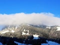 Icy winter atmosphere and low clouds on a snowy peak Stockberg 1781 m in the Alpstein mountain range and in the Obertoggenburg