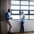 Id like us to explore some of your ideas further. Shot of two businessmen having a discussion in an office. Royalty Free Stock Photo