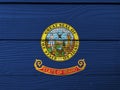 Idaho flag color painted on Fiber cement sheet wall background, state seal of Idaho on a field of blue Royalty Free Stock Photo