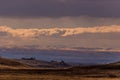 Idaho Ranch at sunset after a light snow under blue sky and broken clouds.