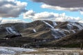 Idaho Ranch at sunset after a light snow under blue sky and broken clouds.