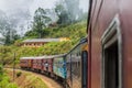 IDALGASHINNA, SRI LANKA - JULY 16, 2016: Local train rides near Idalgashinna village. Locals hang out of door