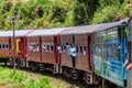 IDALGASHINNA, SRI LANKA - JULY 16, 2016: Local train rides near Idalgashinna village. Locals hang out of door