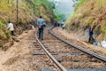 IDALGASHINNA, SRI LANKA - JULY 16, 2015: Workers maintain a railway track between Idalgashinna and Haputal