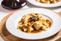 Idalian pasta pappardelle with beef ragu on white plate and red Royalty Free Stock Photo