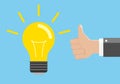 Idea and approval concept. Light bulb and hand with gesture of approval.