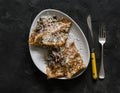 The idea for breakfast, brunch, snack - crepes stuffed with fried mushrooms, ham and cheese on a dark background, top view Royalty Free Stock Photo