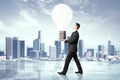 Idea concept, businessman carries a light bulb